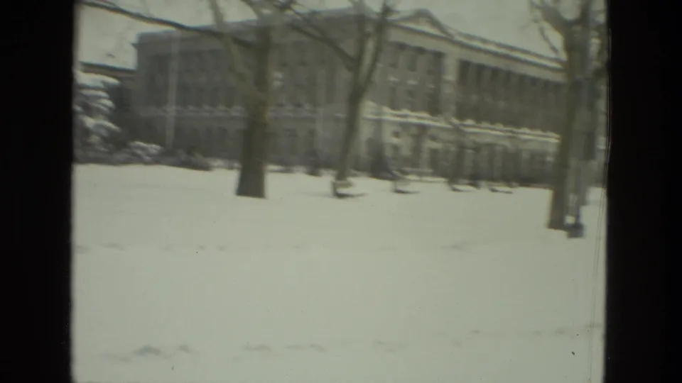 Snow-covered Drexel Hill area with bare winter trees and large buildings visible through soft 8mm exposure.