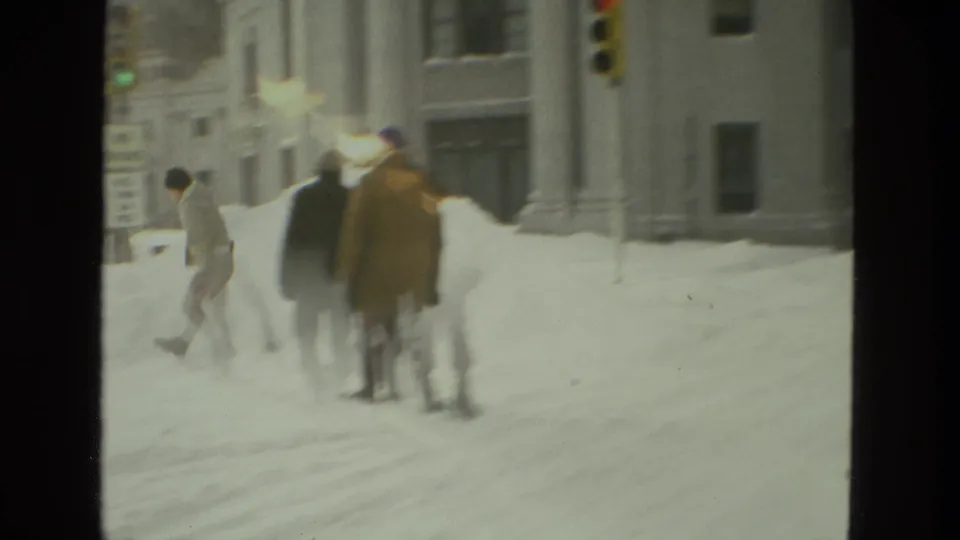 Drexel Hill, Pennsylvania 1978 frame showing pedestrians in winter coats crossing a snow-laden street near a traffic light.