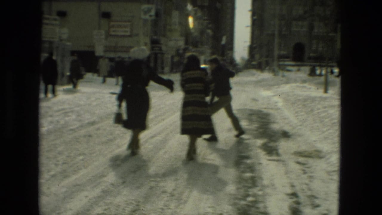 In Drexel Hill, Pennsylvania, pedestrians in winter coats cross a snow-covered street in 1978 home-movie footage.