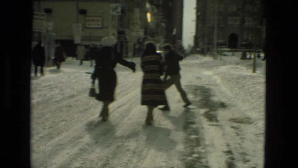In Drexel Hill, Pennsylvania, pedestrians in winter coats cross a snow-covered street in 1978 home-movie footage.