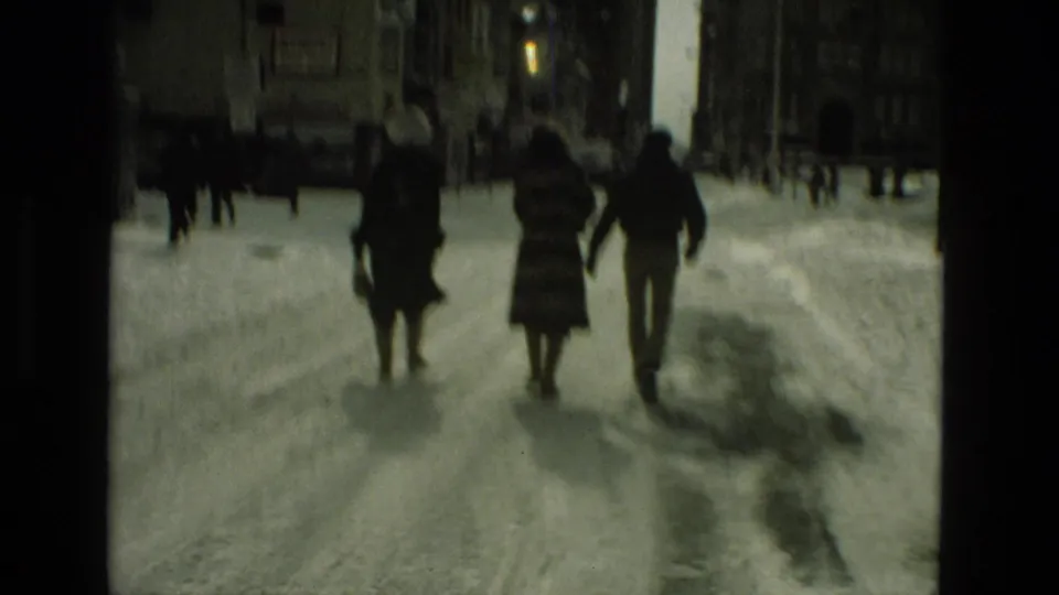 Three bundled figures walk away down a snow-covered Drexel Hill street, seen in soft 1978 8mm footage.