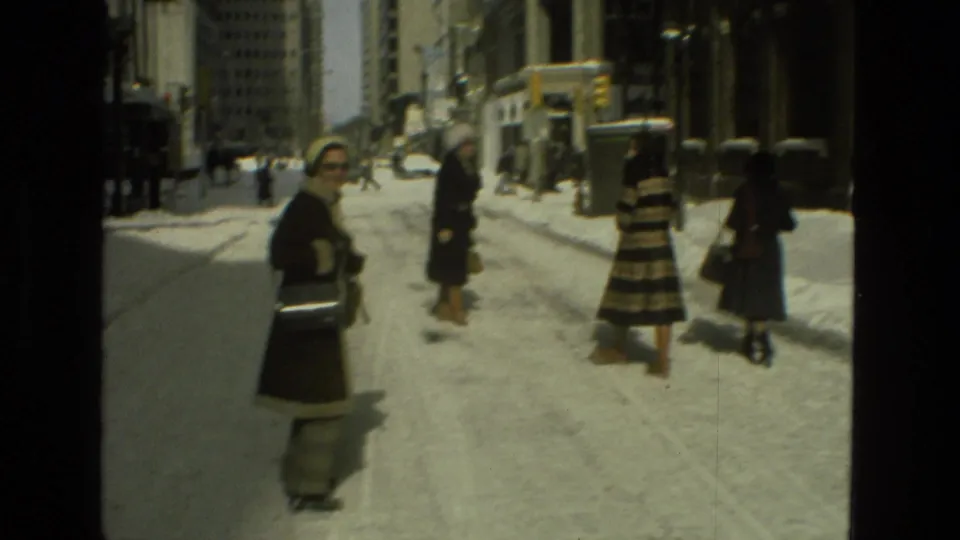 The final frame shows multiple bundled pedestrians, including the striped-coat figure, on a snowy Drexel Hill street with buildings behind them.