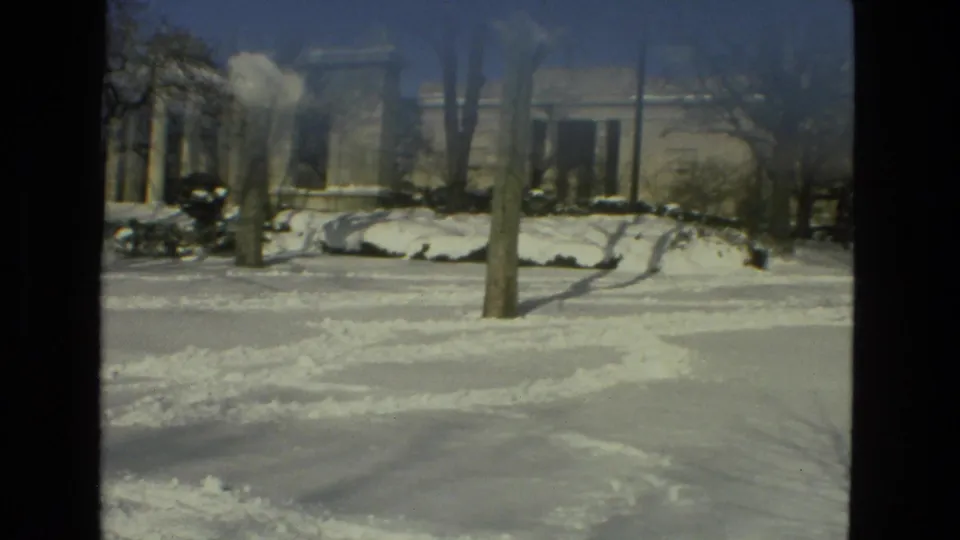 Snowy 1978 campus view with a columned entrance, bare trees, and cleared tracks across the foreground in Drexel Hill, Pennsylvania.