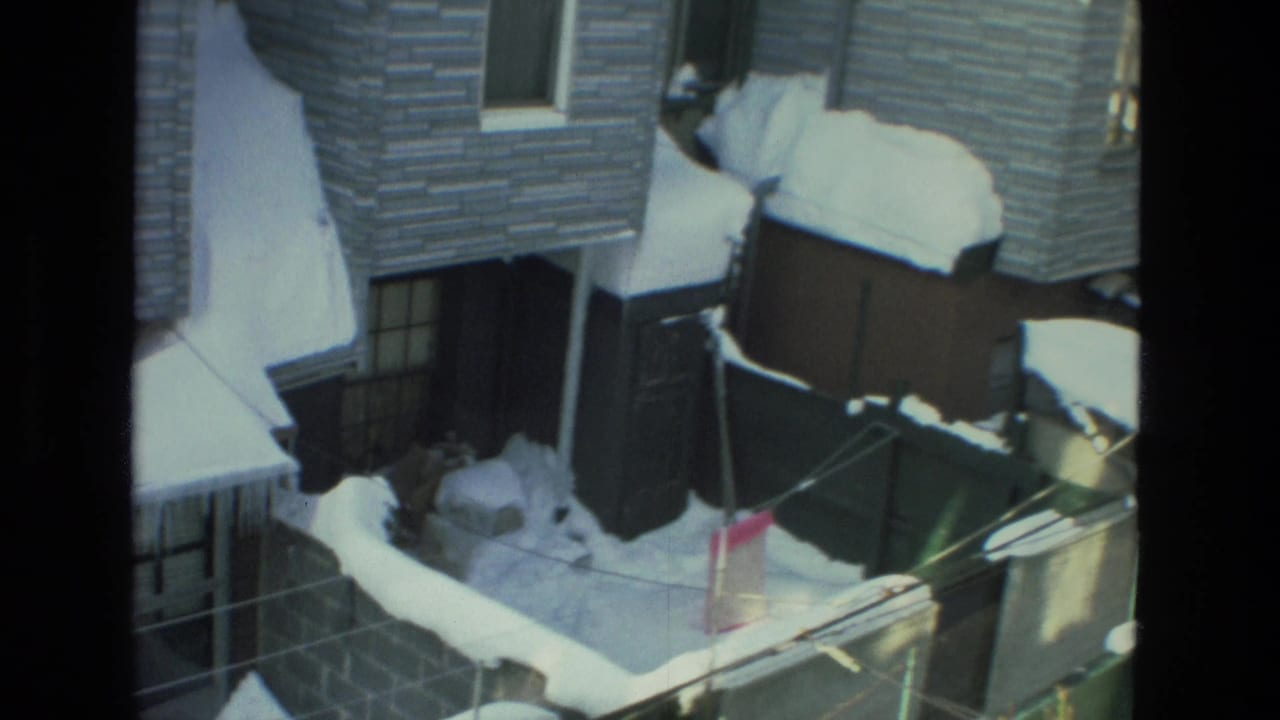 Snow-covered Drexel Hill residential rooftops and yard lines visible from a window in the supplied 1978 home-movie clip.
