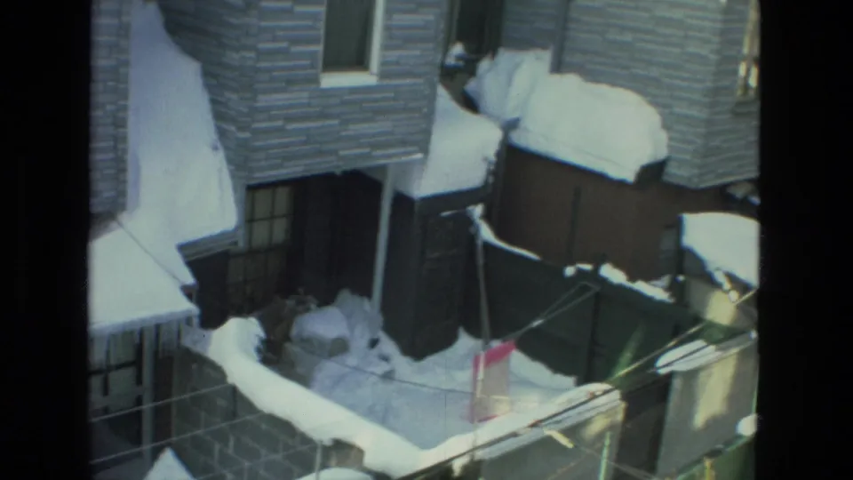 Snow-covered Drexel Hill residential rooftops and yard lines visible from a window in the supplied 1978 home-movie clip.