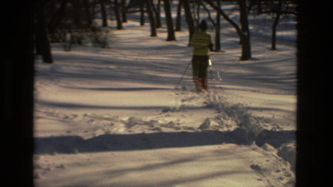 The skier continues away through the snow-covered Drexel Hill woods, leaving a rough track in the 1978 home-movie frame.