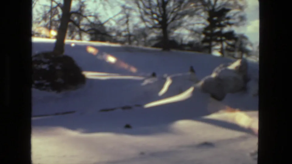 A wide 8mm view shows a snow-covered Drexel Hill hillside with bare trees and distant figures crossing the scene.