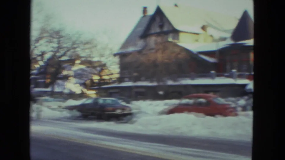 1978 Drexel Hill residential street view with snow-covered houses, bare trees, and parked cars set against high snowbanks.