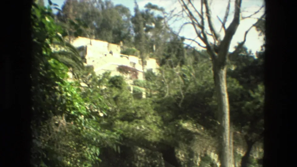 Granada, Spain, 1978 footage appears to show trees and vegetation surrounding pale stone structures on a hillside.