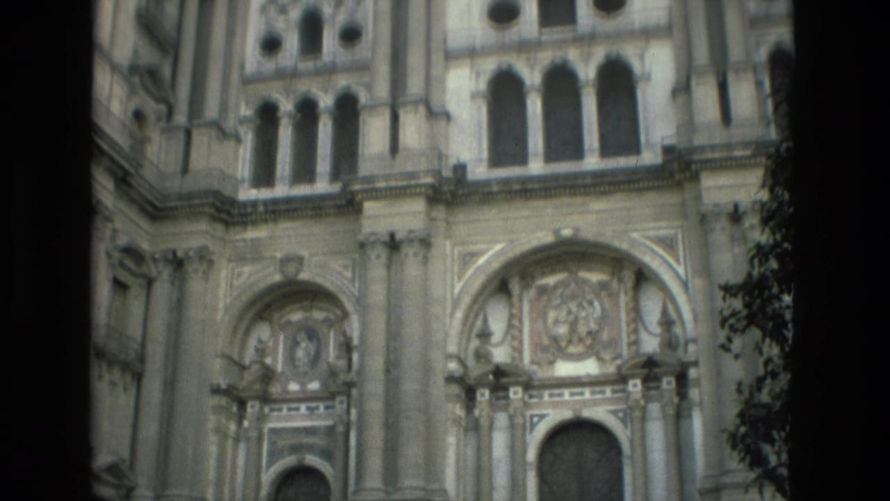 Ornate stone church facade with arched windows and decorative reliefs.