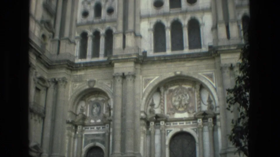 1978 8mm view of an ornate church facade in Granada, Spain, framed close with carved stone details and upper windows.