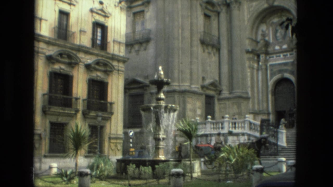 Ornate historic facade with fountain, balconies, plants, and a horse carriage near steps.