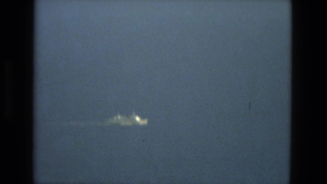 The bright object appears larger and blurred in the upper blue-gray sky, framed by dark 8mm borders and contact-sheet separation.