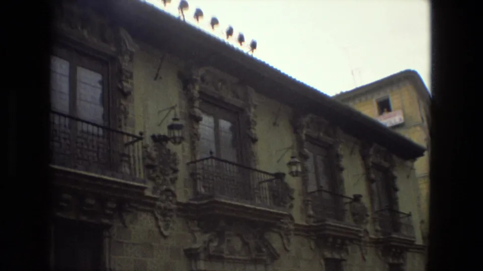 An angled 1978 Córdoba view follows the ornate facade, with balconies, hanging lamps, roof tiles, and a small upper structure at right.