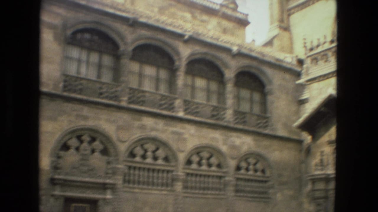 Ornate stone facade with arched windows and decorative balcony details.