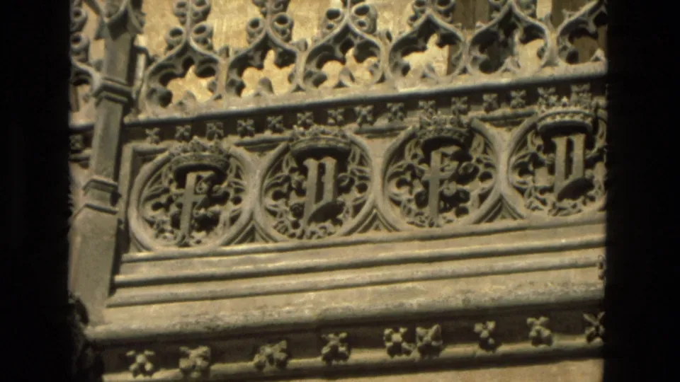 Close 1978 Cordoba frame showing carved Gothic stone tracery, circular ornament, floral details, and weathered masonry on a church exterior.
