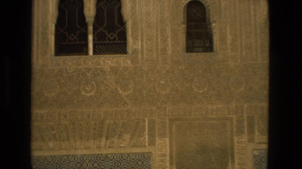 1978 8mm travel frame showing Moorish-style architectural detail with arched windows and patterned stonework in Spain.