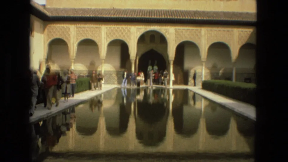1978 visitor footage shows tourists beside the reflecting pool and arched courtyard at the Alcázar of Córdoba.