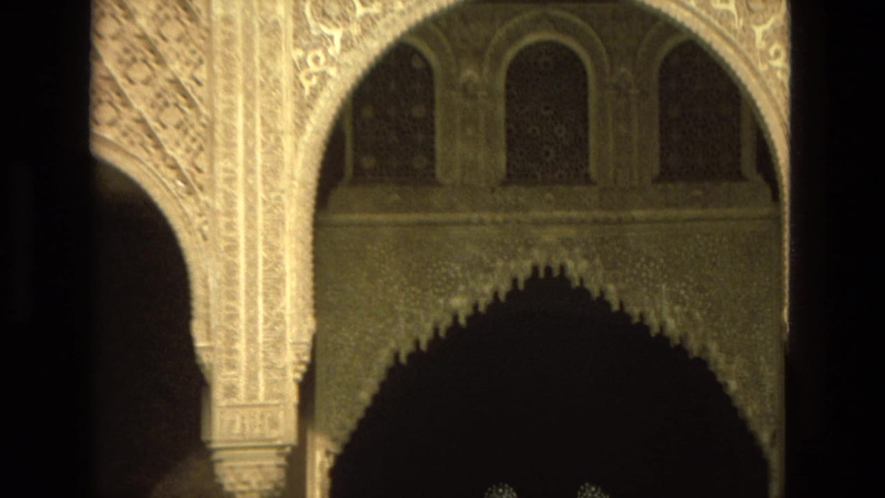 Ornate carved arches and shadowed architectural details inside a Moorish-style structure.