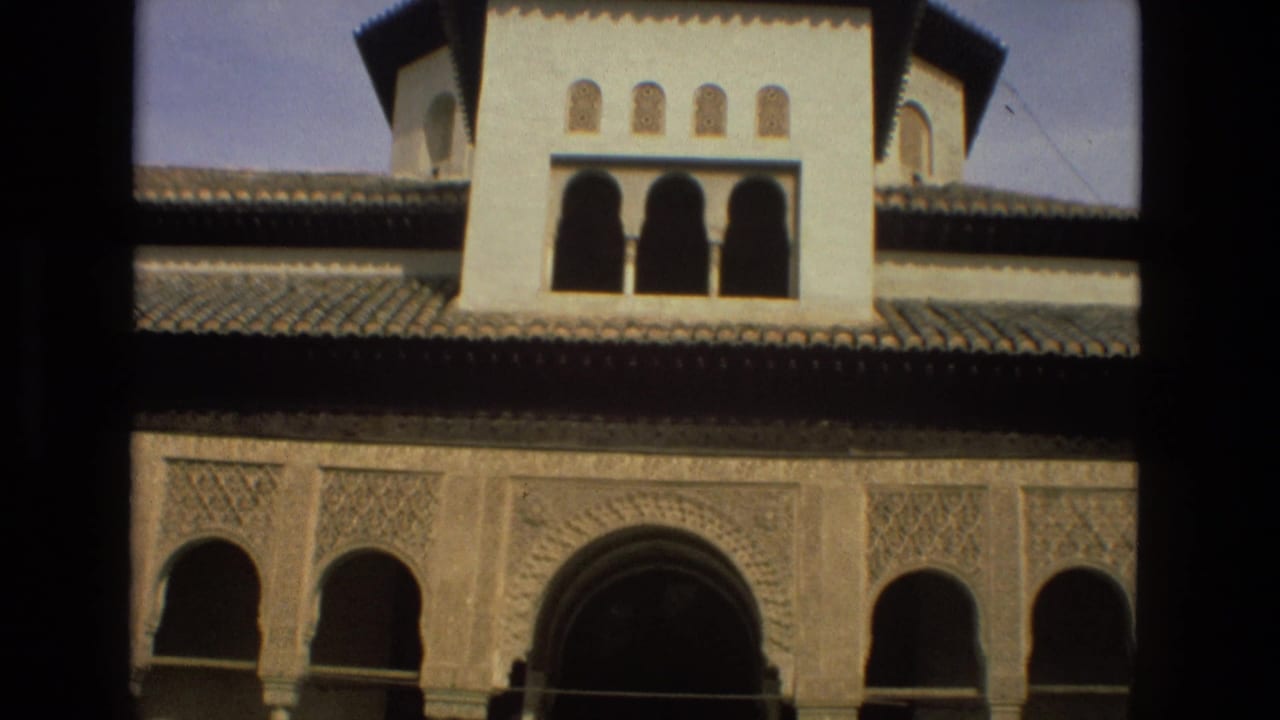 1978 8mm travel frame from Córdoba, Spain, showing a Moorish-style facade with arches, carved wall panels, and tiled rooflines.