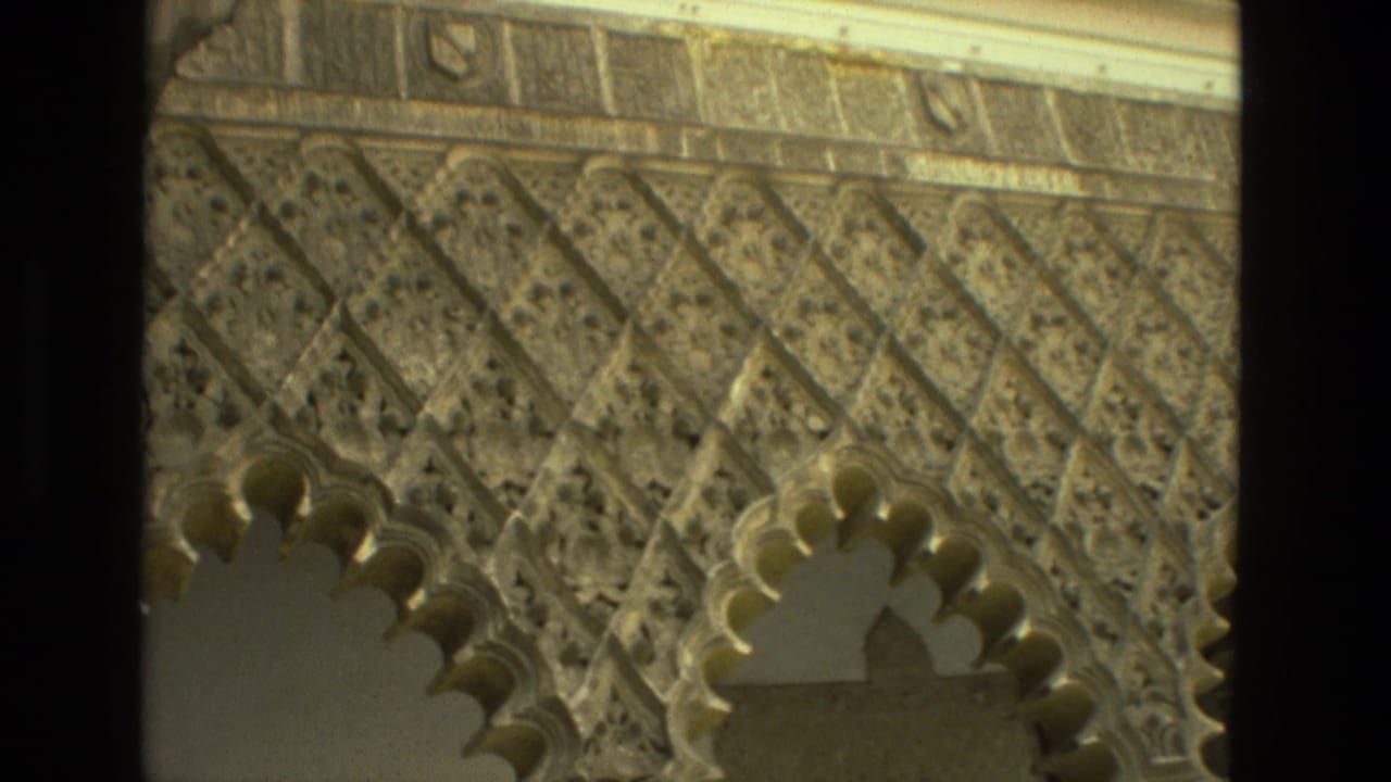 1978 8mm Seville footage showing carved geometric stonework and scalloped arches in a historic religious courtyard.