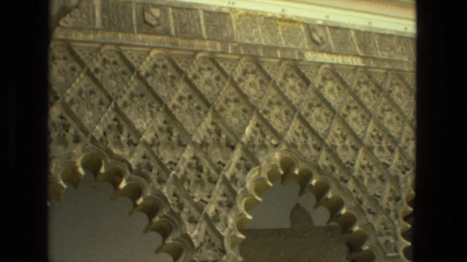 1978 8mm Seville footage showing carved geometric stonework and scalloped arches in a historic religious courtyard.