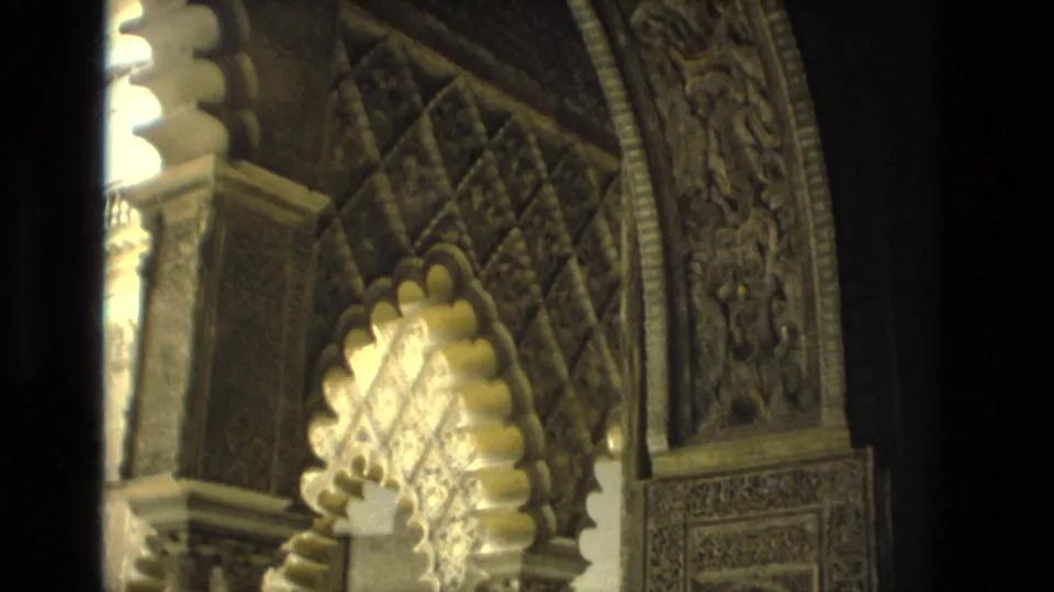 1978 Seville home-movie view of a scalloped arch with columns, carved borders, and patterned upper wall surfaces.