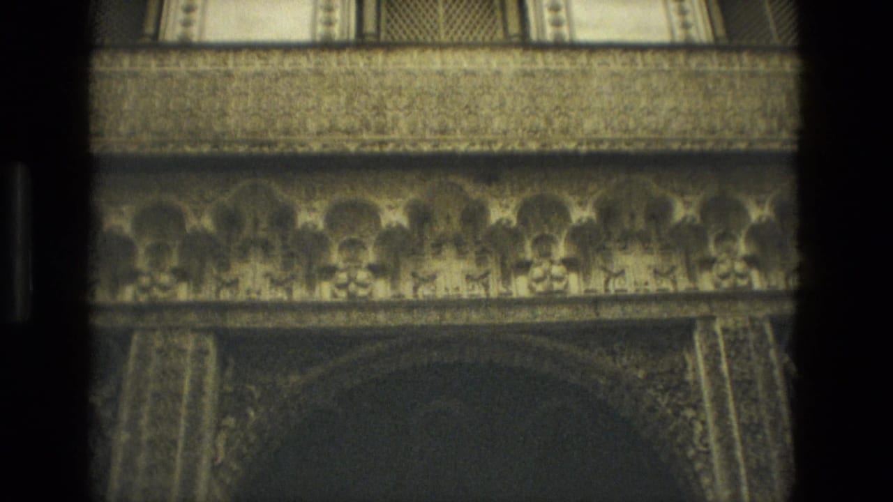 Ornate interior arches and carved stone bands seen in soft focus.