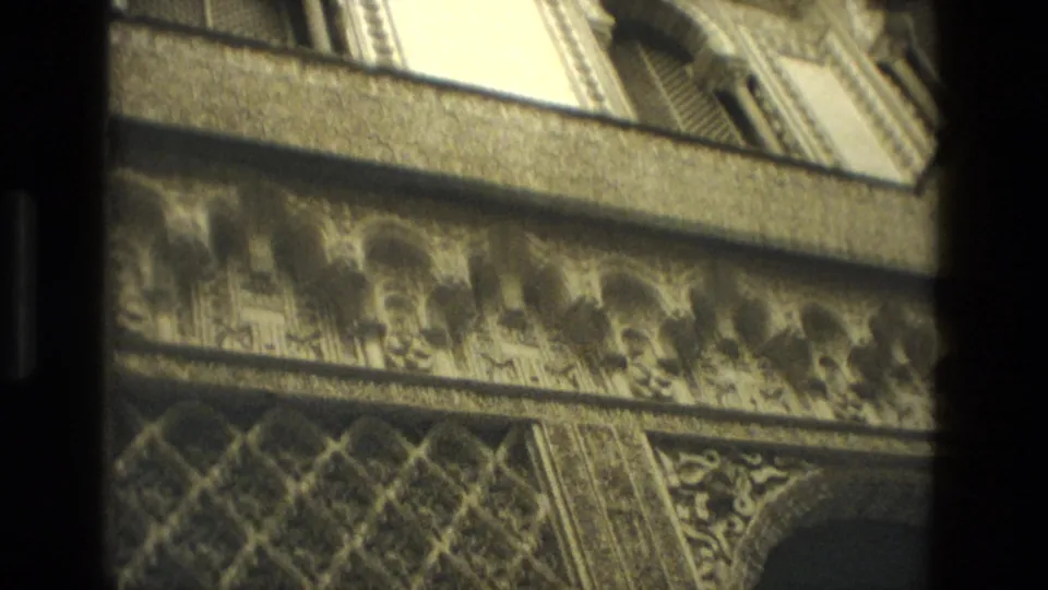 1978 Seville 8mm frame showing a horizontal carved frieze, patterned arch surfaces, and warm interior stone tones.