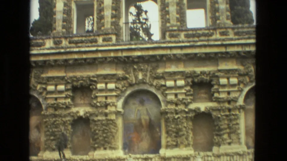 1978 Seville 8mm frame showing carved facade details and painted arched niches, including one central fresco-like panel.