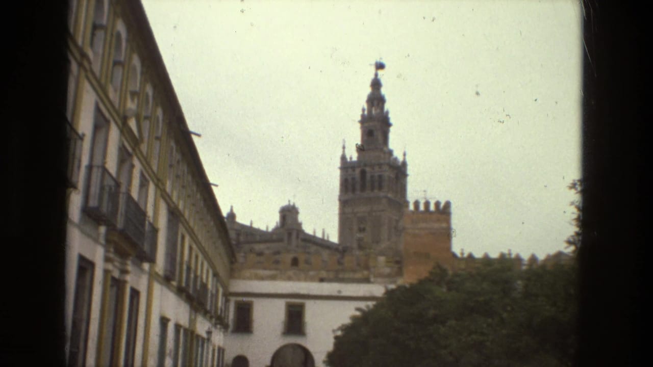 Balconied street facade leading toward cathedral tower.