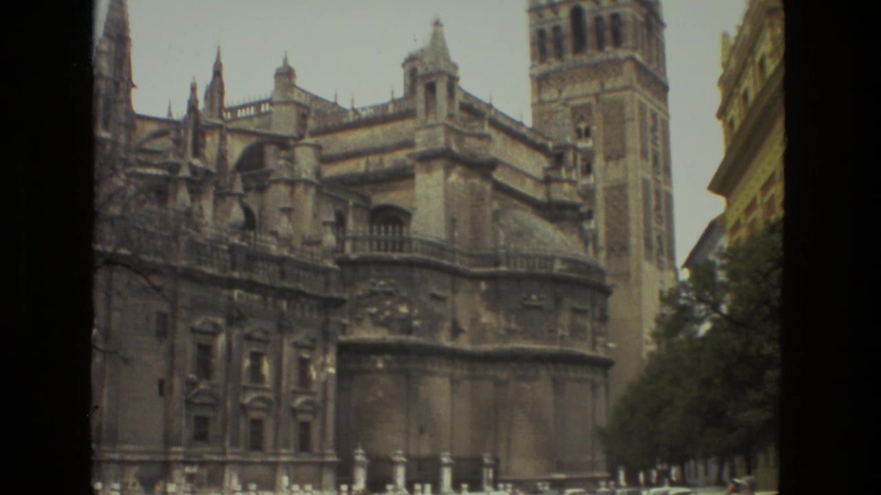 Seville Cathedral facade and Giralda tower seen from street level.