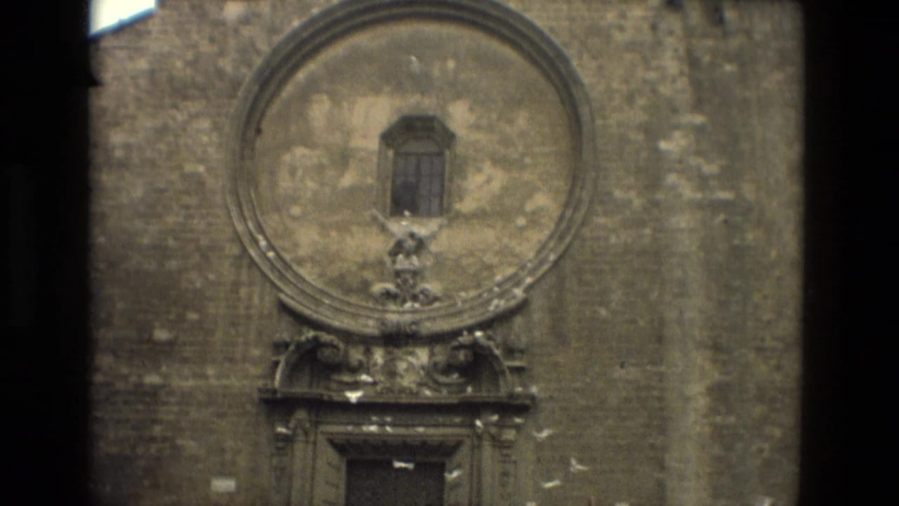 Weathered stone church facade with ornate circular detail above a doorway.