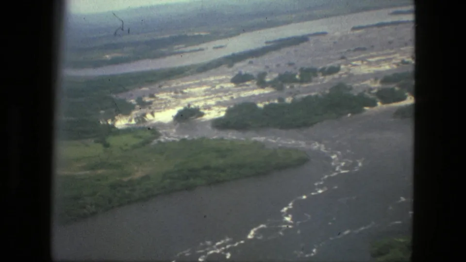 1979 Manaus-area aerial 8mm frame showing curved river channels, vegetated islands, and pale rapids or shallows.