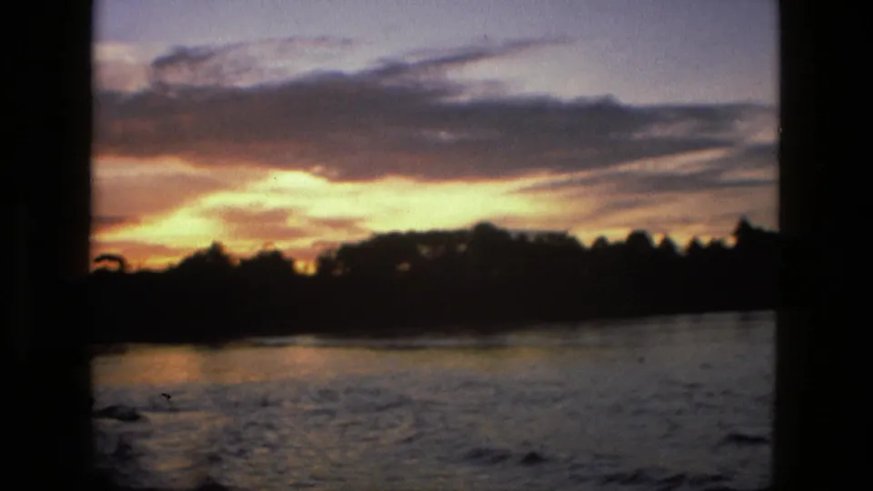 The final frame shows the Manaus river landscape at dusk, with glowing clouds above dark shoreline trees and reflective water.