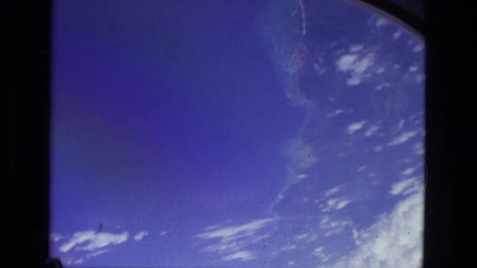 1979 8mm view near Manaus, Brazil, appearing to show blue atmosphere and scattered clouds framed by a rounded window edge.