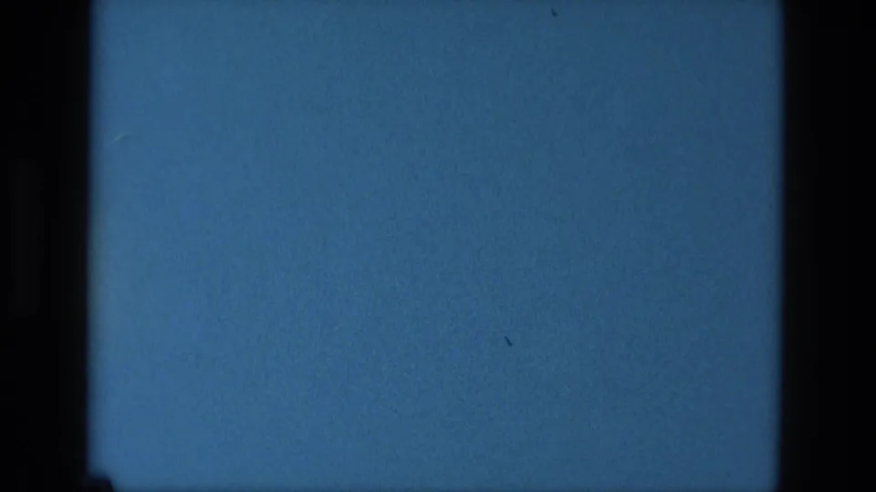 1979 Manaus 8mm frame of a blue screen-like surface, with dark vertical edges, subdued grain, and no readable broadcast content.