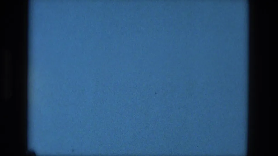 1979 Manaus 8mm frame showing the lower portion of a blue screen or filmed display, with dark edges and visible film texture.