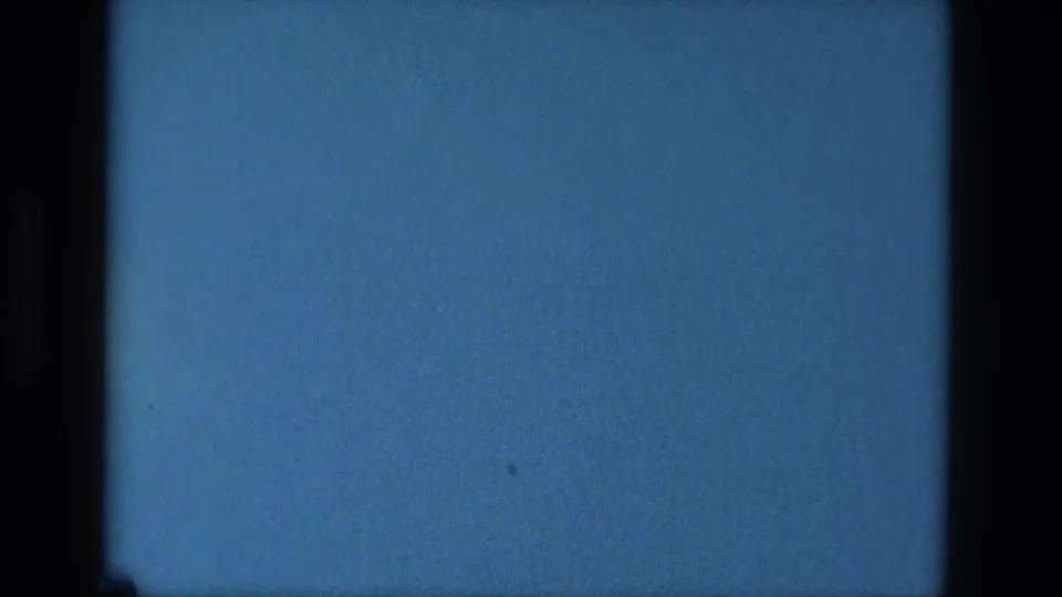 Blue-tinted 1979 8mm reel-end frame from Manaus with black film edges, grain, and small dust marks.