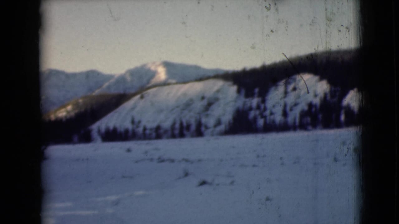 Snowy mountain landscape with evergreens and dark 8mm frame edges.