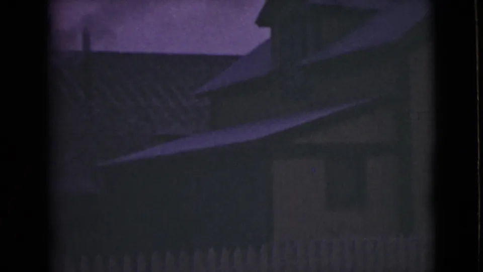 1946 Alaska home-movie frame with a shadowed building, sloped roof, fence pickets, and a small window or door shape.