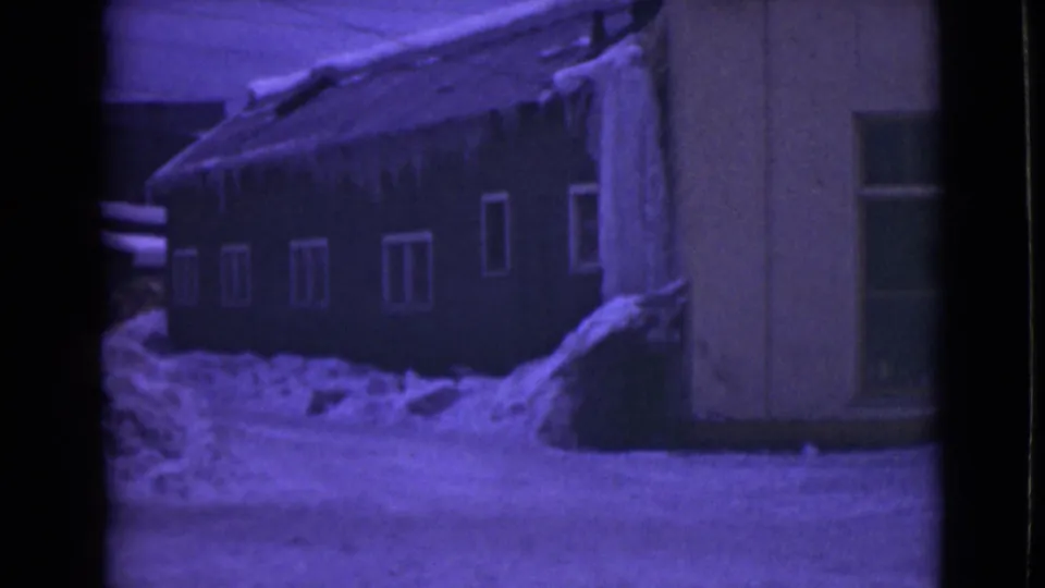 1946 Alaska 8mm frame showing a snow-covered residential exterior with icicles and small windows.
