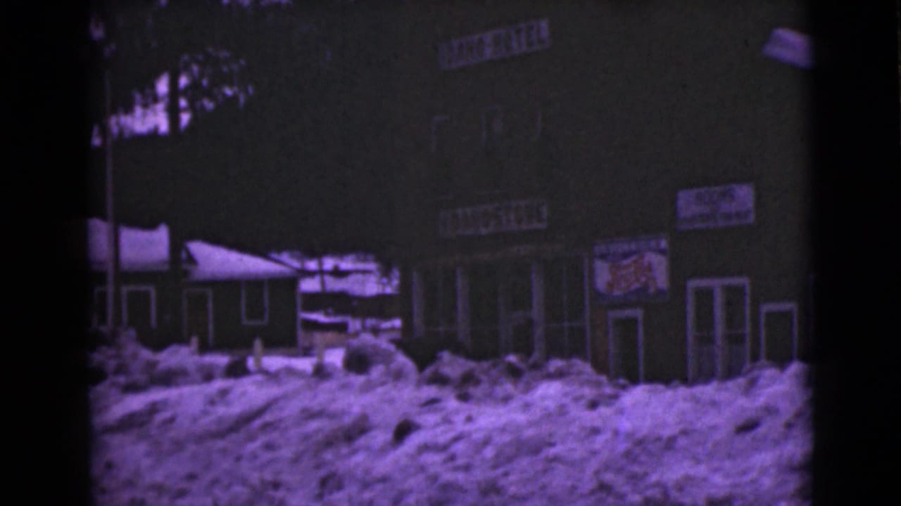 Snow-covered building exterior with Lion Hotel signage and dark storefronts.