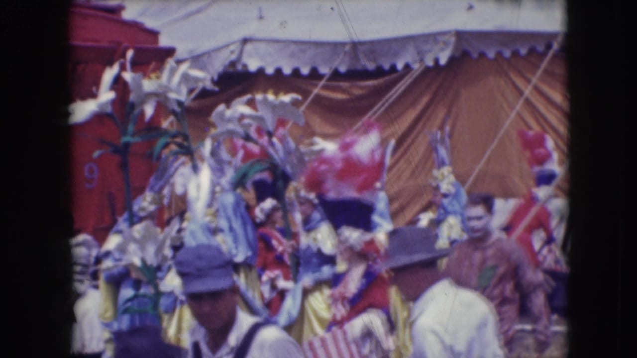 1948 Ringling Brothers Sarasota scene with feathered performers, tent canvas, and audience members crossing the foreground.