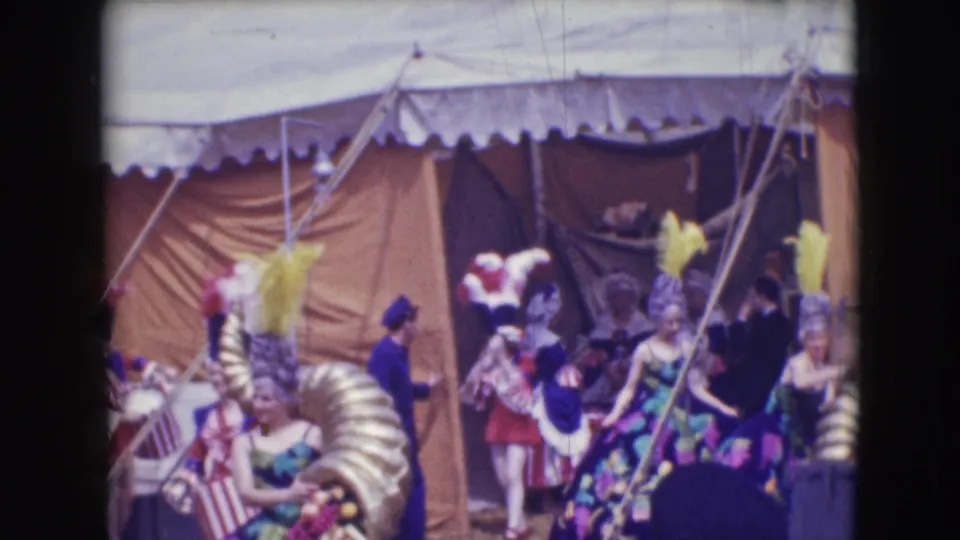 The final frame shows circus performers in 1948 Sarasota gathered beside canvas tenting, feathered hats, and a large gold stage prop.