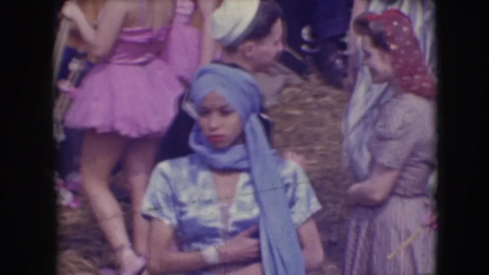 The final frame shows the blue-costumed performer with arms crossed among Ringling Brothers Sarasota performers in varied costumes.