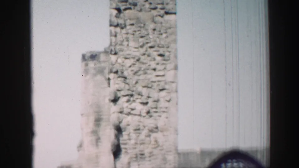 1952 Edinburgh home-movie view of a stone church ruin with part of an arched window near the lower edge.