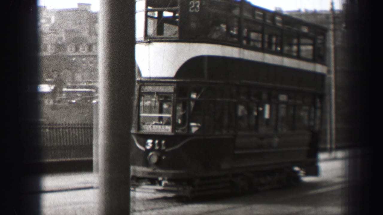 Double-decker tram moving through an Edinburgh street in black-and-white 8mm footage from 1952.