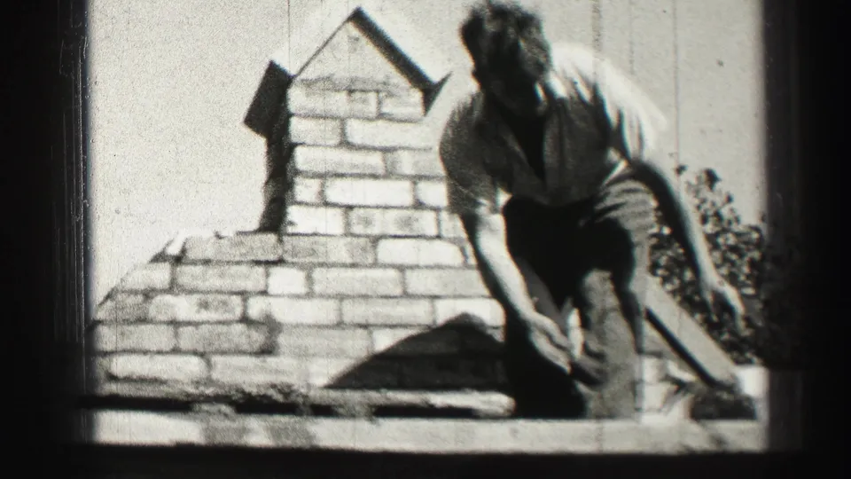 A worker bends near the brick chimney on a rooftop, with the 1952 Edinburgh setting supported by clip metadata.