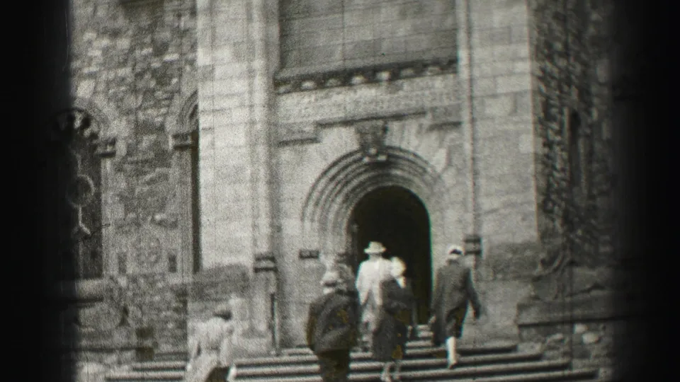 In Edinburgh, Scotland, 1952 metadata, adults in hats and formal dress ascend steps toward a carved stone archway.